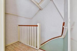 A stairway with a railing and a door photo