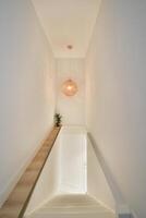 A staircase with a light hanging from the ceiling photo