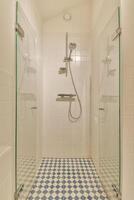 A bathroom with a shower and a tiled floor photo