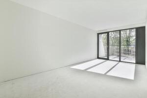 Empty room with large windows and white walls photo