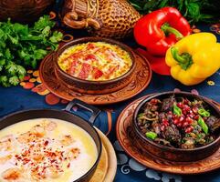 Georgian cuisine being served on a table with a blue tablecloth photo