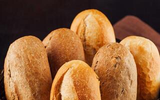 Freshly baked bread rolls resting in a basket photo