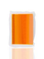 Vacuum packed block of cheddar cheese isolated on white background photo