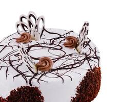 Delicious round chocolate cake with white icing and chocolate decorations isolated on white background photo