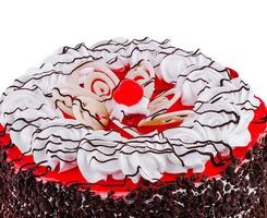This delicious cake is decorated with frosting and a cherry on top photo