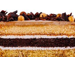 Delicious layered cake with chocolate curls and icing on white background photo
