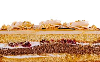Delicious cake is showing its layers of biscuit and cream on a white background photo