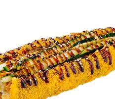 Tempura sushi roll topped with cucumber and sesame seeds on white background photo