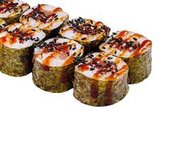 Sushi rolls set covered with black sesame seeds and sauce isolated on white background photo