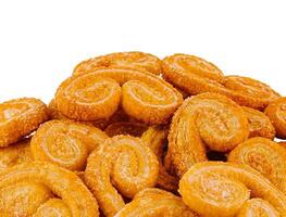 Pile of palmier cookies covered in granulated sugar isolated on white background photo