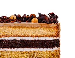 Delicious layered cake with chocolate curls and icing on white background photo