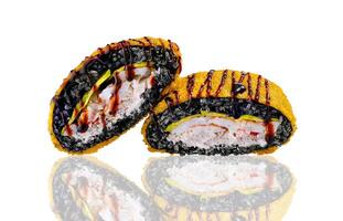Two delicious black sushi rolls with crab meat, avocado and unagi sauce reflecting on white background photo