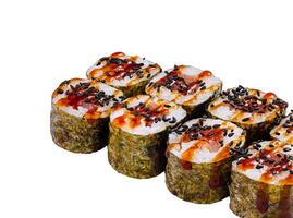Sushi rolls set covered with black sesame seeds and sauce isolated on white background photo