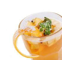 Cocktail with apple slices, orange peel and mint decorated with powdered sugar photo