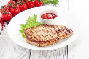 Grilled pork steak with ketchup photo