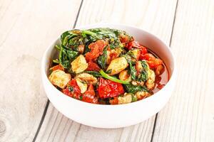 Chicken with tomato and spinach photo