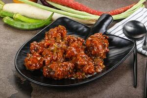 Manchurian chicken with sauce and spices photo