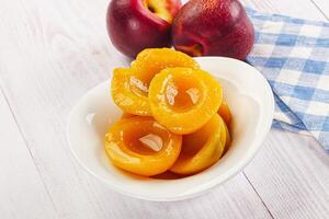 Canned peaches with sweet syrope photo