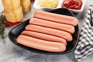 Boiled sausages with ketchup and mustard photo