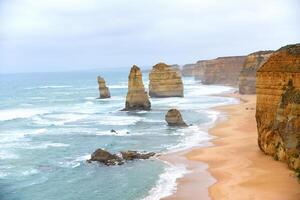 View of the 12 Apostles in cloudy day, Erosion of the mainland coast's limestone cliffs on The Great Ocean Road is an Australian National Heritage-listed at south-eastern coast of Victoria, Australia photo