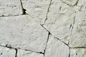 Abstract white stone wall texture with irregular shapes isolated on horizontal full frame background. photo