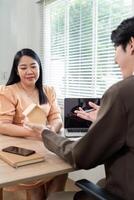 Real Estate Consultation. Client and Agent Discussing Property Details photo
