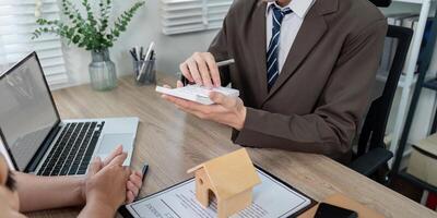 Real Estate Agent Assessing Loan Options with Client for Optimal Property Investment photo