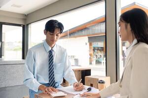 Finance Specialist Reviewing Reports and Using Calculator in Cafe Setting photo