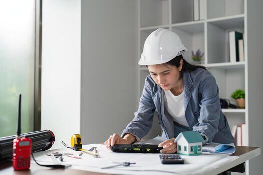 Civil Engineer Evaluating Construction Plans Using a Level for Accurate Project Execution photo
