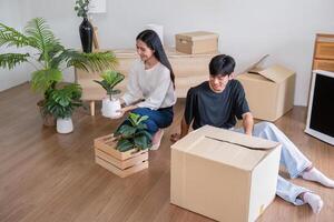 Practical Home Setup Couple Arranging Plants and Boxes photo