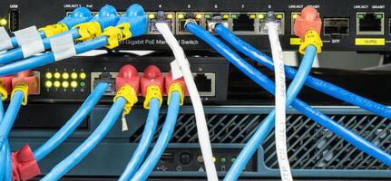Network hub with LAN cable connected to patch cables connected to internet data center photo