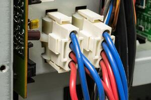A cables Wire-to-Wire Connector System, featuring various colors like red and blue with signal and power carrying capabilities photo