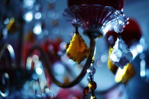 an abstract dark photo with a chandelier and candelabra hung with Venetian crystal of different colors. beautiful weighing pieces of glass in the form of crystals. antique style room decoration and