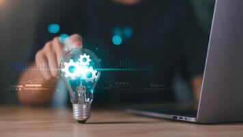 solution concept and demonstrating leadership strategies ,ideas ,thought process ,innovation and brain power from brainstorming ,A light bulb representing the power of thought in the human hand photo