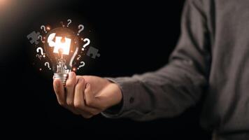 solution concept and demonstrating leadership strategies ,ideas ,thought process ,innovation and brain power from brainstorming ,A light bulb representing the power of thought in the human hand photo