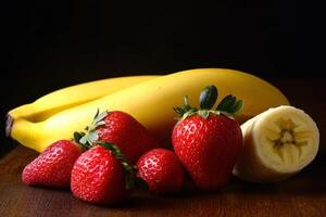 Fresh bananas and strawberries arranged on a wooden surface photo