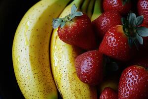 Fresh strawberries and bananas in a bowl on a wooden table photo
