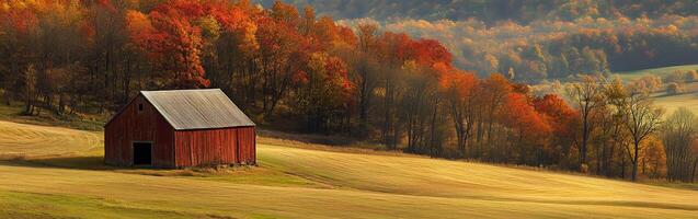 Rural landscape with a red barn surrounded by vibrant autumn foliage photo