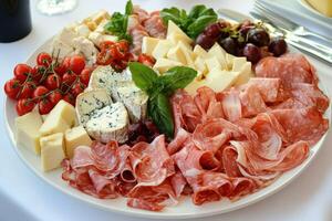 Delicious charcuterie board with assorted meats and cheeses at a gathering photo