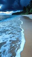 Tropical beach at dusk with gentle waves lapping the shoreline photo