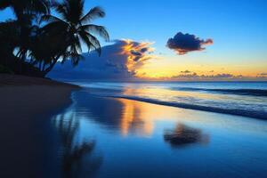 Tropical beach at dusk with calm waters reflecting colorful sky photo