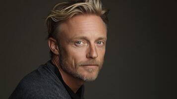 Portrait of a man with blonde hair in a casual setting indoors photo