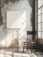 An empty canvas on a cracked wall beside an old wooden chair photo