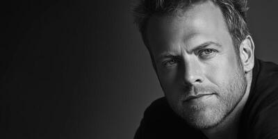 Close-up portrait of a man with thoughtful expression in black and white photo