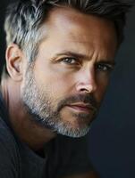 Portrait of a man with short gray hair and a beard, thoughtful expression photo