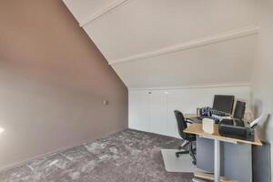 A room with a desk and a computer photo