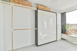 A white room with a sliding door and a window photo