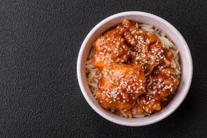 Asian food boiled rice with meat with sweet and sour sauce, spices and herbs photo