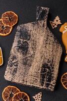 Empty wooden cutting board with copy space with gingerbread cookies and Christmas decor photo