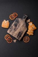 Empty wooden cutting board with copy space with gingerbread cookies and Christmas decor photo